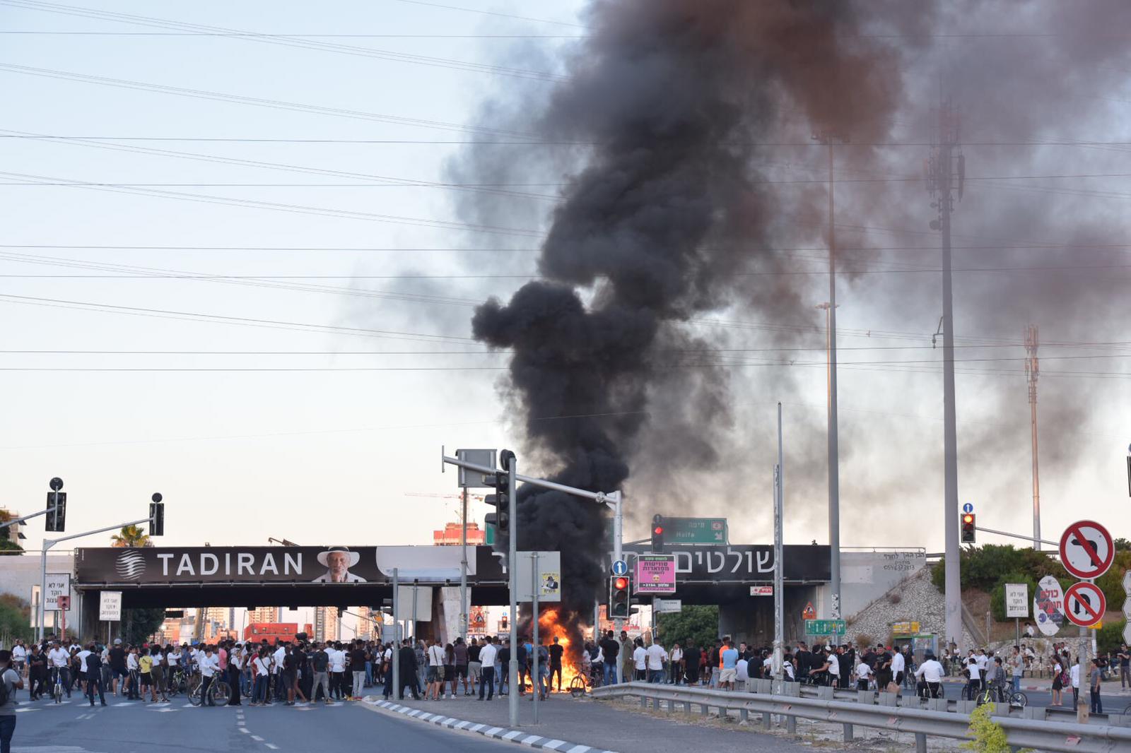 תיעוד: שוטר נפגע מאבנים שיידו מתפרעים, וירה באוויר