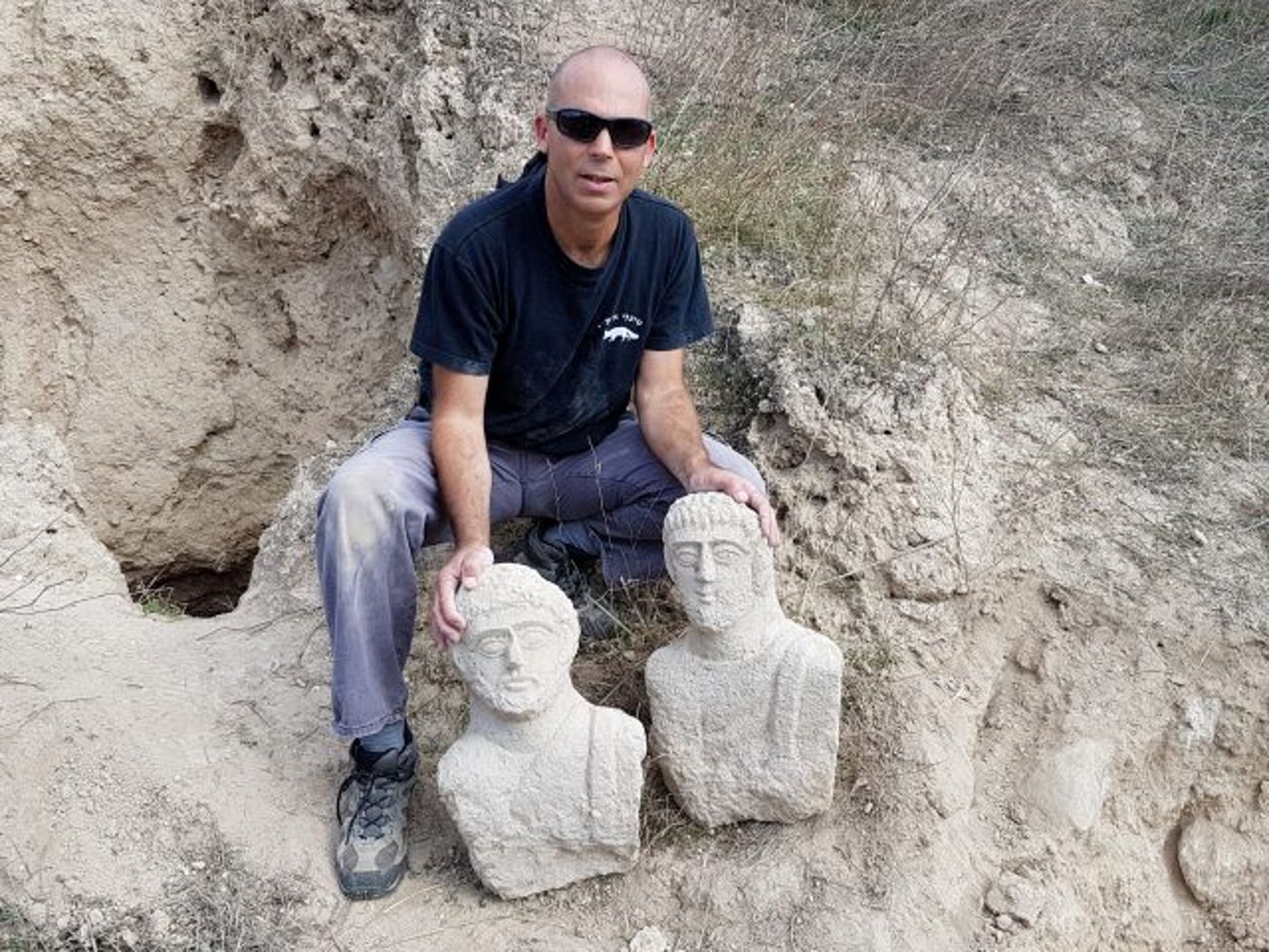 ניר דיסטלפלד, מפקח היחידה למניעת שוד ברשות העתיקות עם הפסלים שנחשפו.