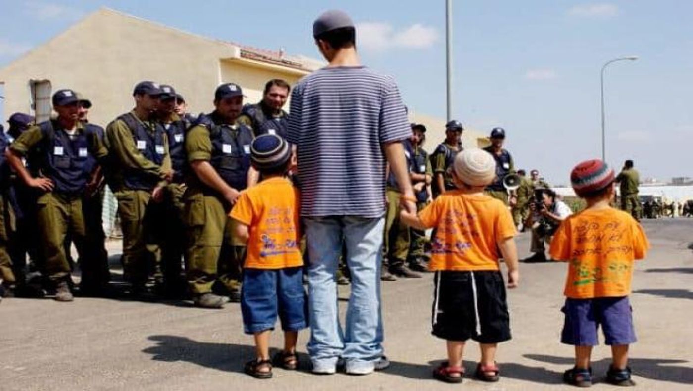 ילידה של מוריה סולימן מחלקים ממתקים לחיילים ביום בו גורשו מביתם.